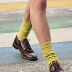 Man wearing orange ribbed crew socks by Escuyer, made in Portugal