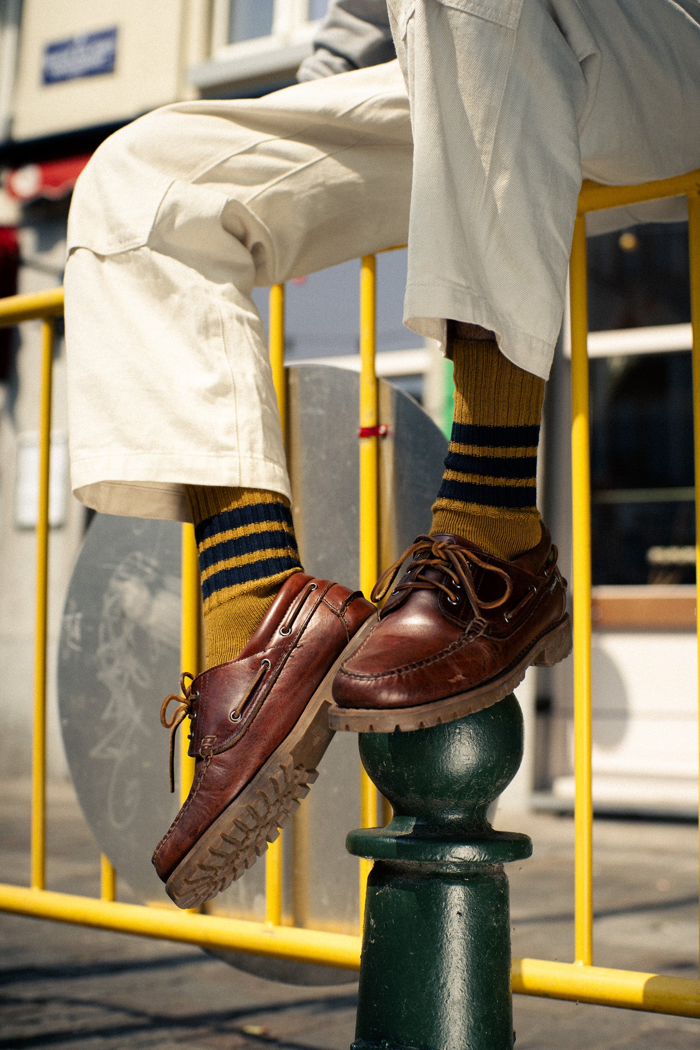 Man wearing yellow and pink striped crew socks by Escuyer, made in Portugal