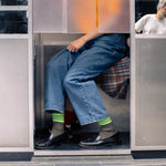 Person wearing Escuyer 5 Stripes Socks — vintage athletics-inspired, hand-linked toe, made in Portugal