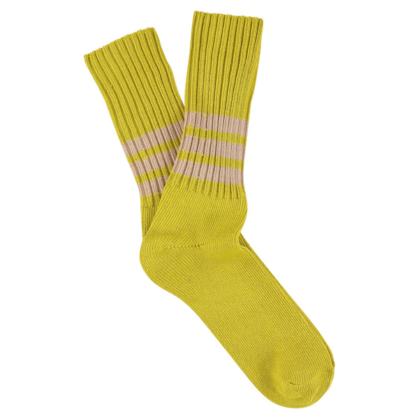 Yellow sock with pink stripes on a white background