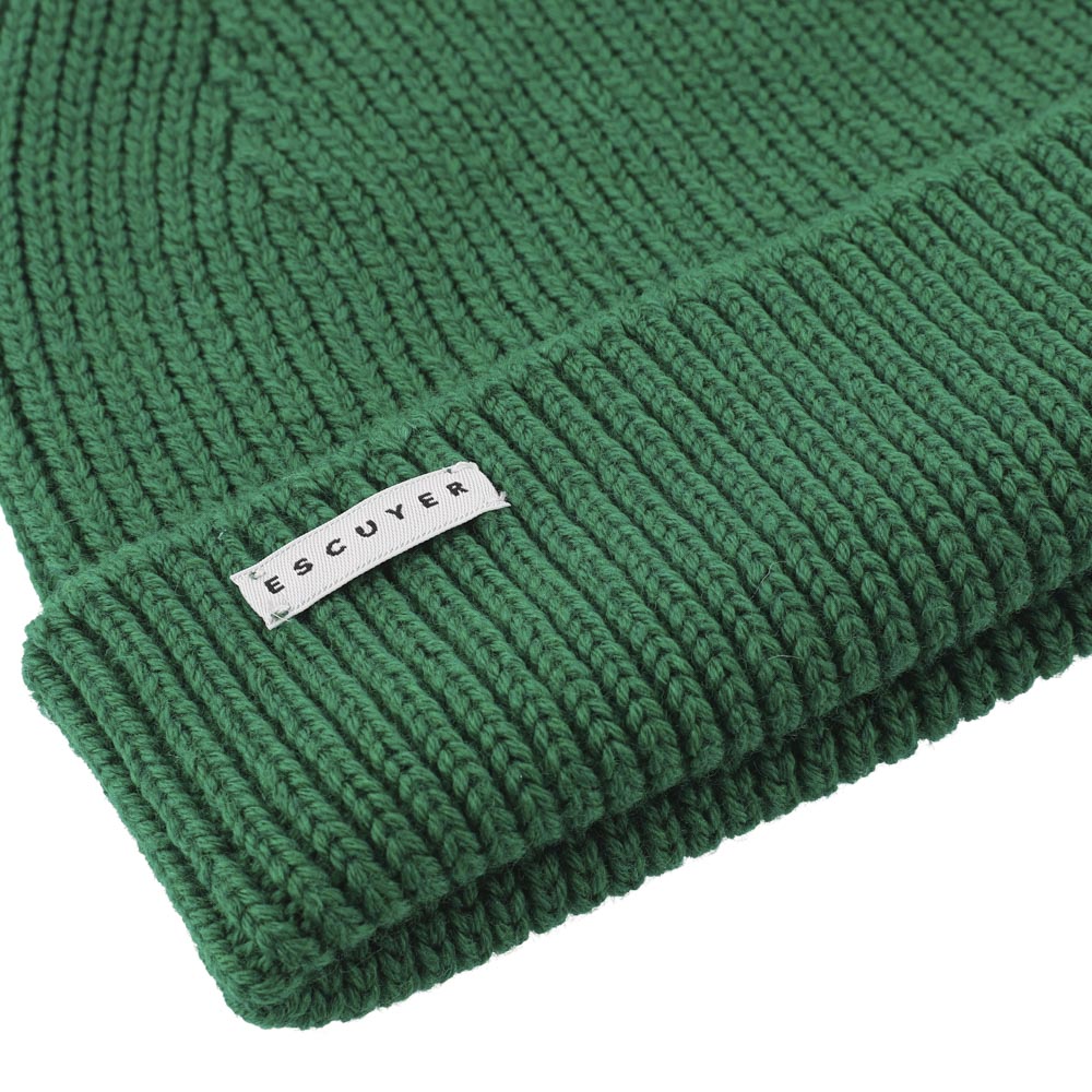 Green knit beanie with a visible brand label on a white background