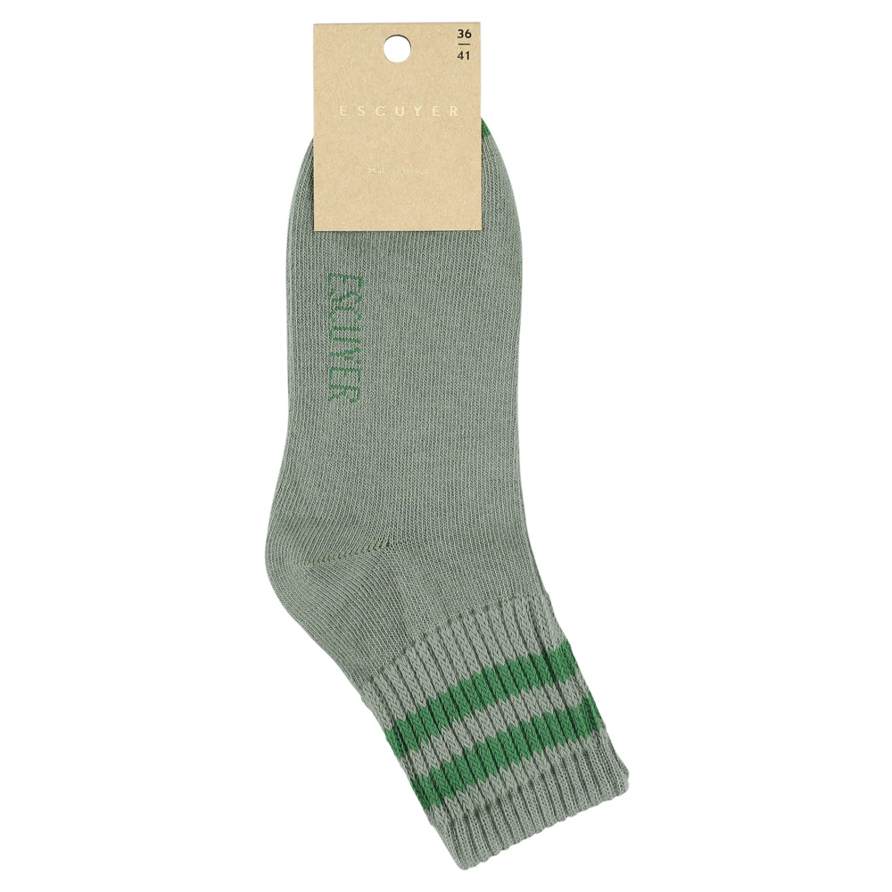 Green sock with a brand label on a white background