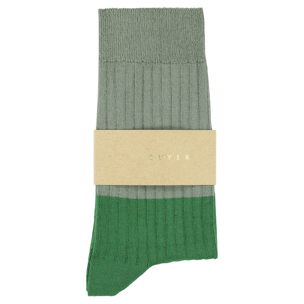 Green sock with beige band on a white background