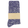 Blue and white patterned sock with a beige label on a white background