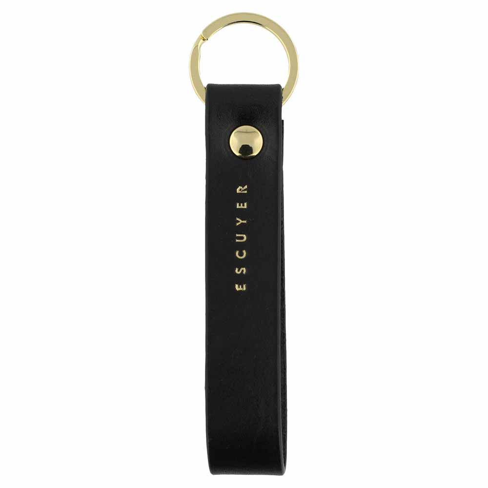 Escuyer black leather keychain — Italian vegetable tanned leather tab with gold metal ring and gold Escuyer logo