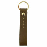 Escuyer khaki leather keychain — Italian vegetable tanned leather tab with gold metal ring and gold Escuyer logo