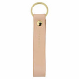 Escuyer pink leather keychain — Italian vegetable tanned leather tab with gold metal ring and gold Escuyer logo