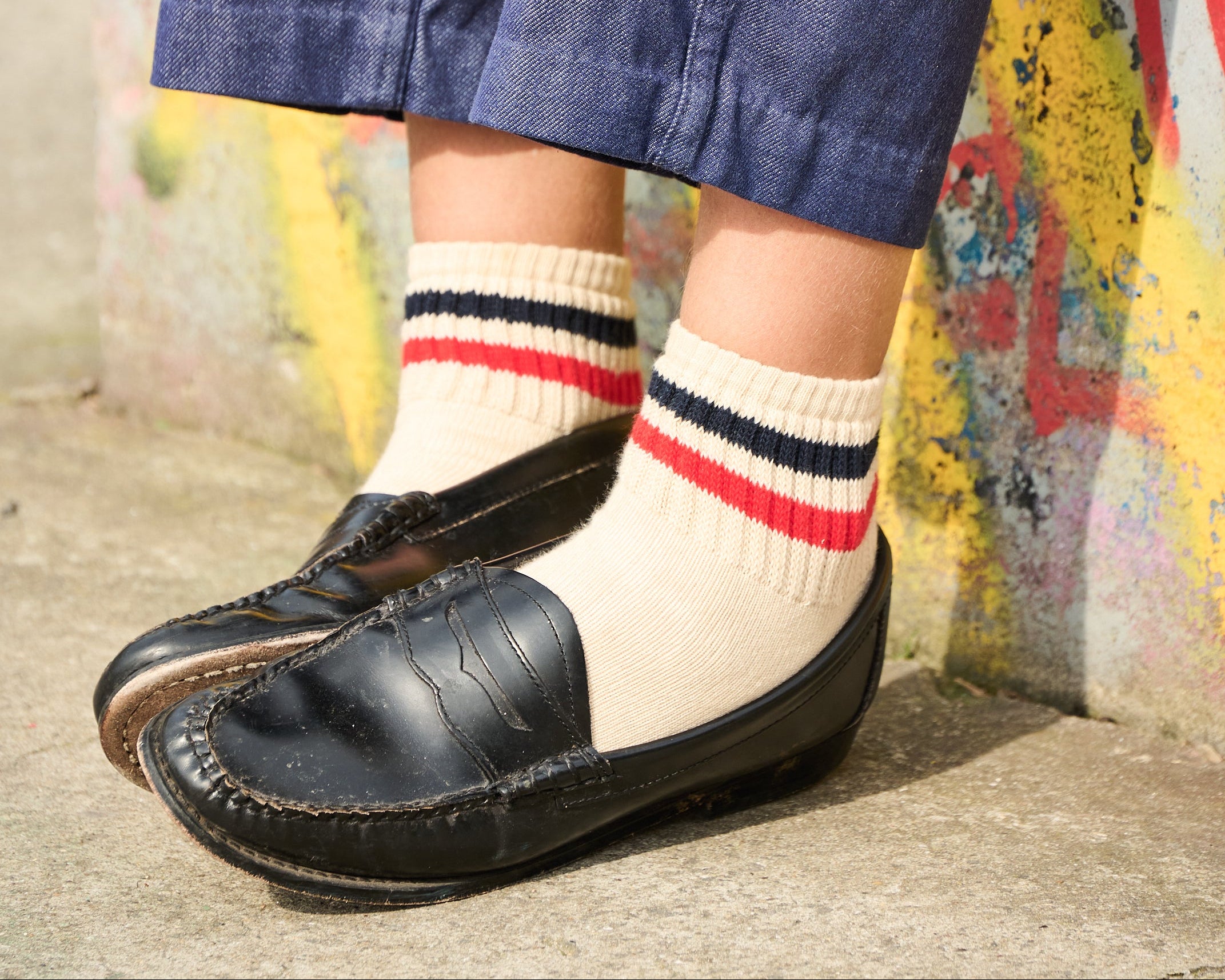 Woman wearing Escuyer striped ankle socks Red / Ochre with black loafers — spring summer style