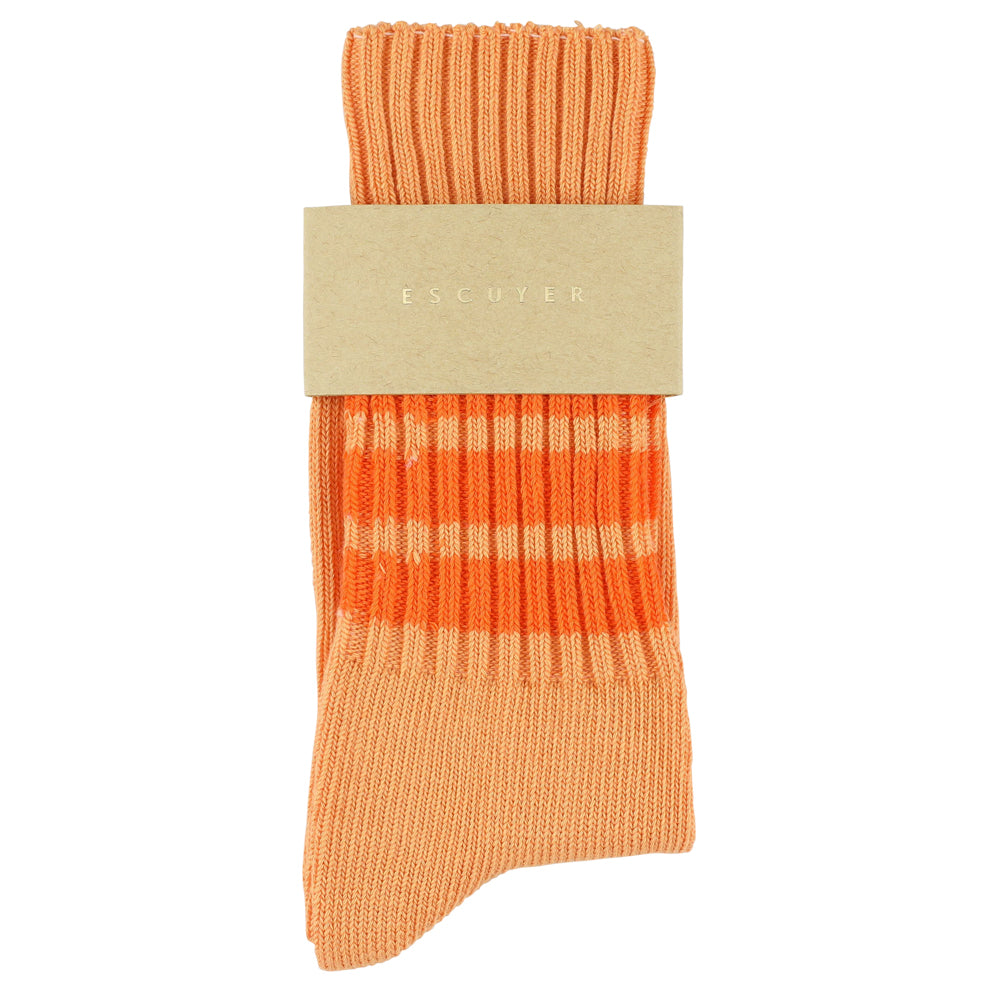 Orange sock with a beige label on a white background