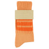 Orange sock with a beige label on a white background