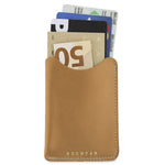 Escuyer natural leather card sleeve holding cards and a folded banknote — holds up to 8 cards