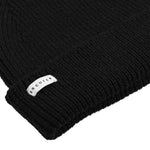 Side view of black ribbed merino wool beanie with folded cuff