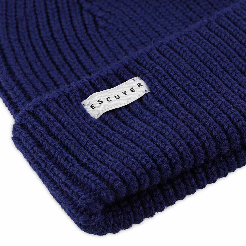 Side view of bold blue ribbed merino wool beanie with folded cuff