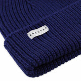 Side view of bold blue ribbed merino wool beanie with folded cuff