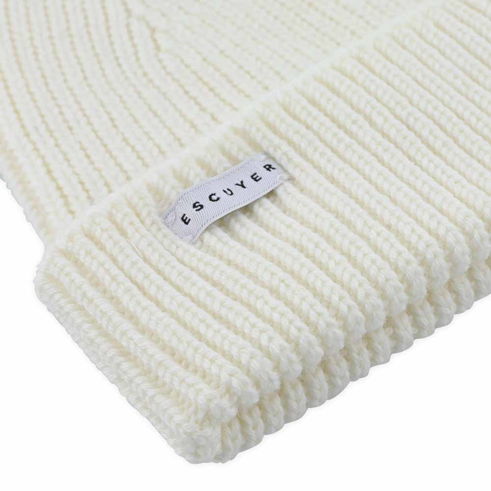 Side view of cream ribbed merino wool beanie with folded cuff