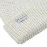Side view of cream ribbed merino wool beanie with folded cuff