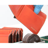 Escuyer light brown and orange billfold wallet — atelier production detail, handmade in Portugal